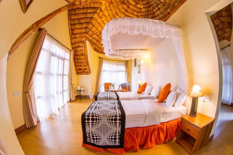 Twin beds beneath a canopy mosquito net at Farm of Dreams Lodge, Karatu