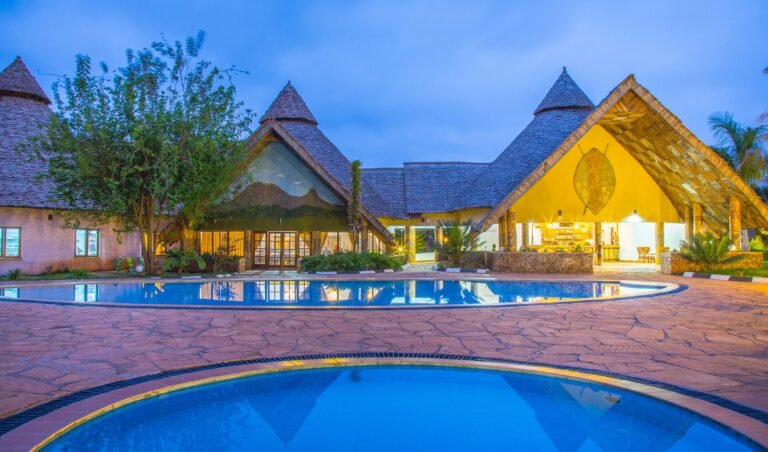 A wide view across the lawns and buildings at Farm of Dreams Lodge, Karatu